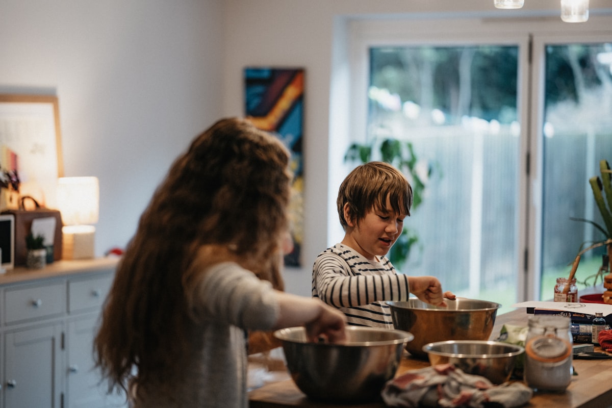 Children chopping fresh vegetables in a cooking class